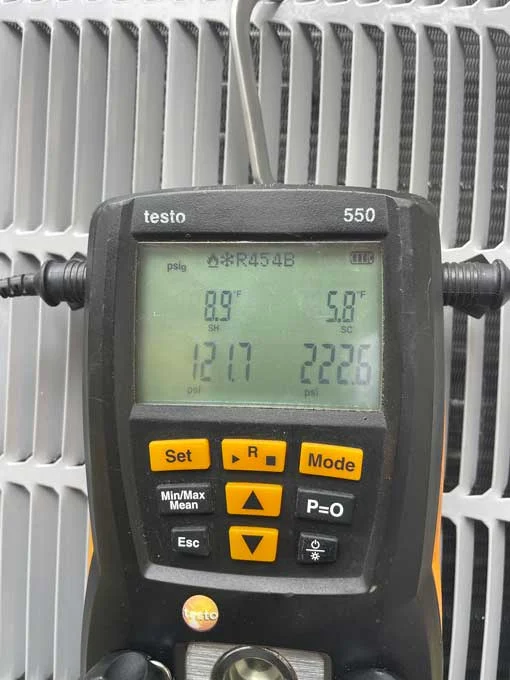 HVAC technician checking refrigerant levels during AC installation in Boerne TX