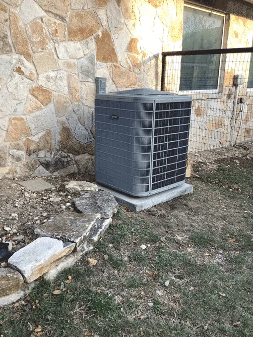 New heat pump condenser installed outside home in Kerrville TX