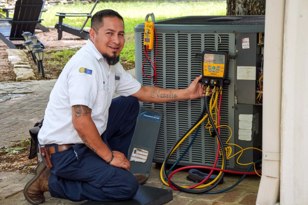 HVAC Technician Inspecting Air Conditioning Unit - Fredericksburg, TX