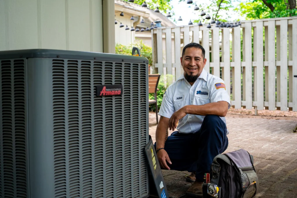 HVAC Technician with Air Conditioning Unit Outdoors - Fredericksburg, TX