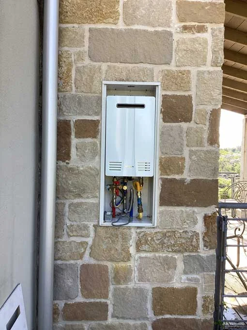 new tankless water heater installed outside home in Fredericksburg TX