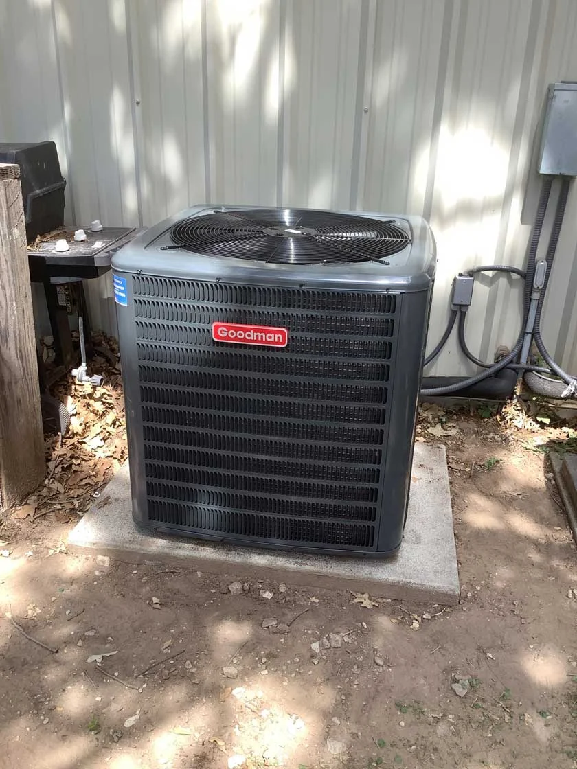 A recently installed Goodman HVAC condenser unit outside a business in Fredericksburg TX