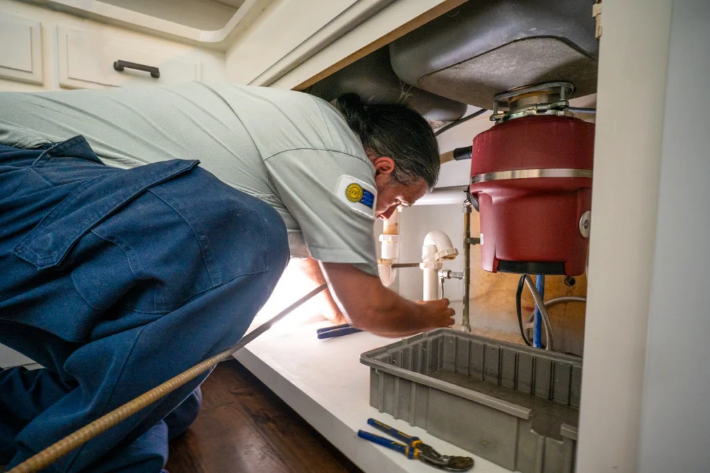 Plumber Inspecting RV Sink Plumbing System - Fredericksburg, TX