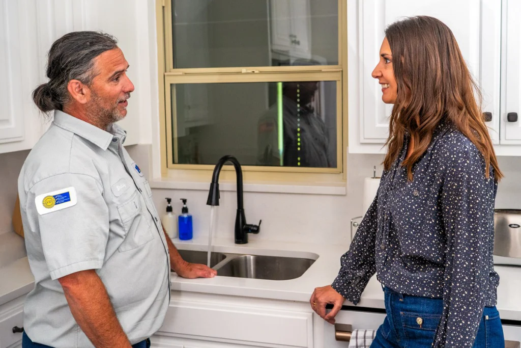 Professional Plumber Discussing Kitchen Sink Installation - Fredericksburg, TX