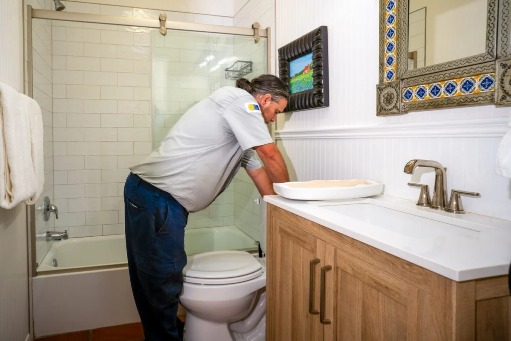 Professional Plumber Inspecting Bathroom Sink Installation - Fredericksburg, TX