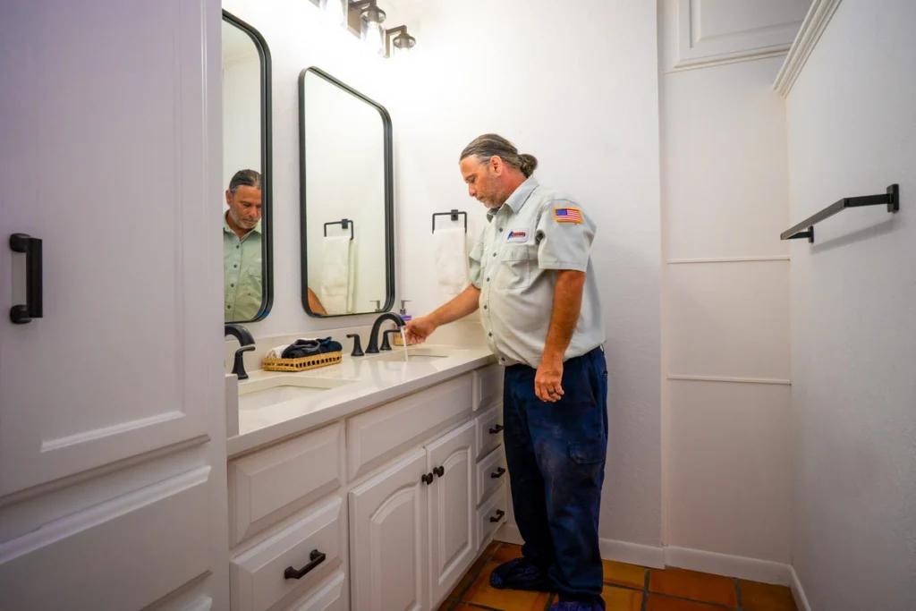 Professional Plumber Inspecting Modern Bathroom Vanity - Fredericksburg, TX