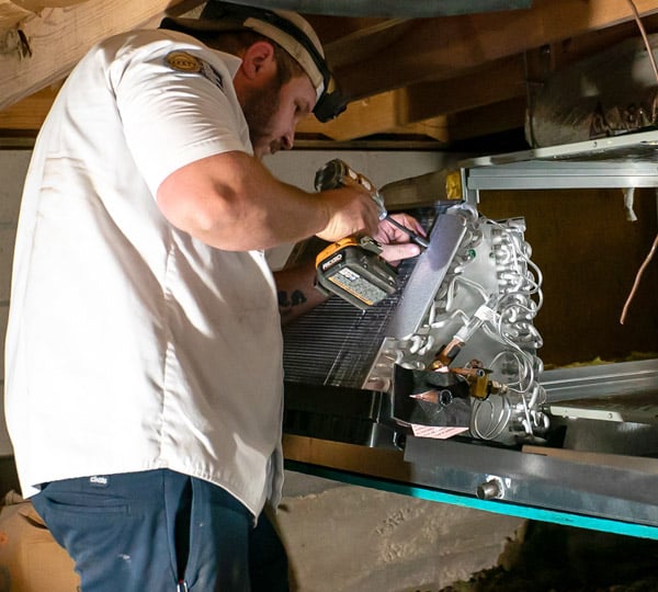 Technician installs new air conditioning system