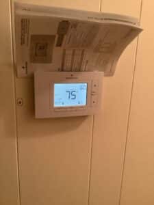 New digital thermostat installed in a home