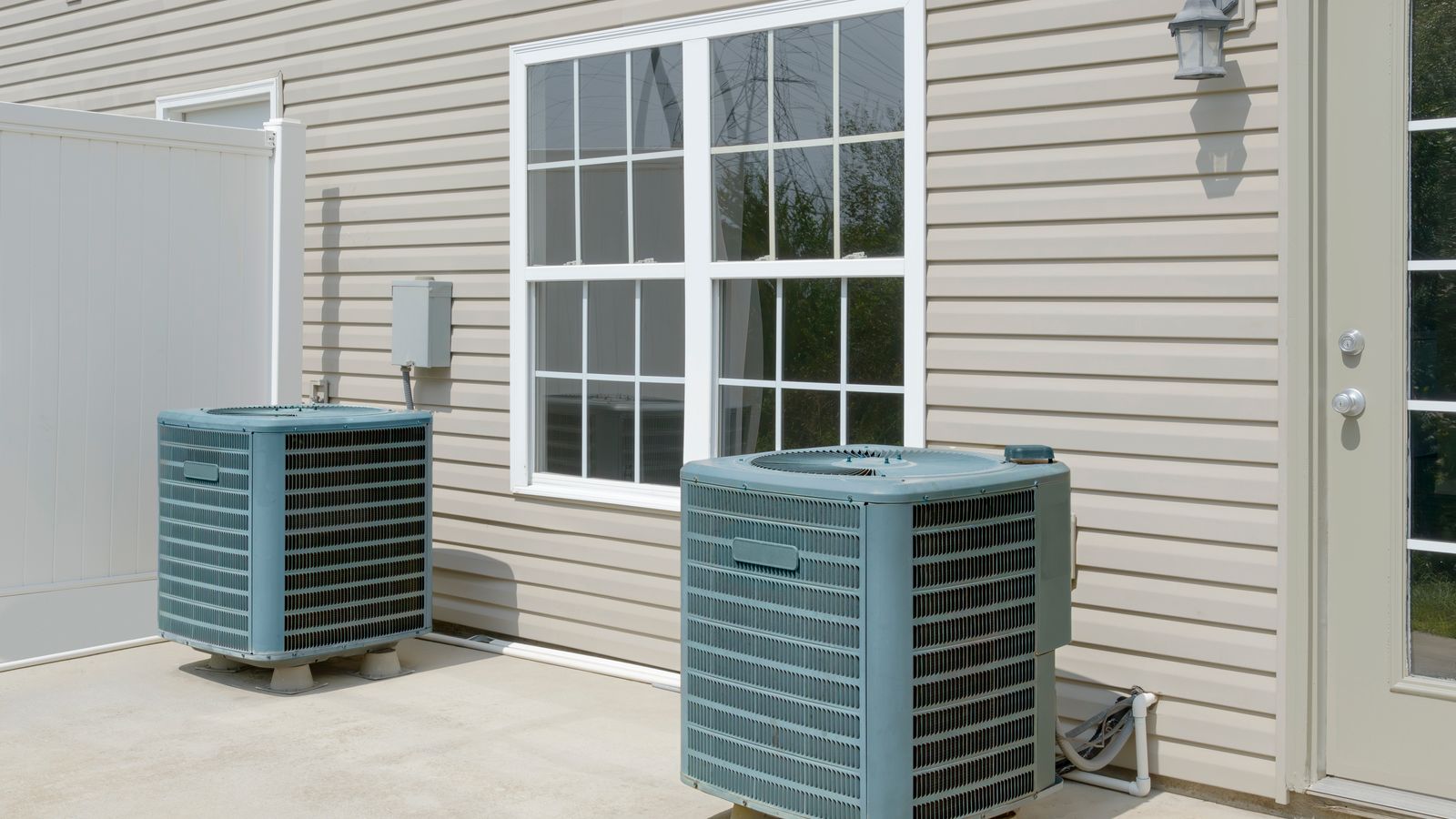 Dual AC unit on patio outside home