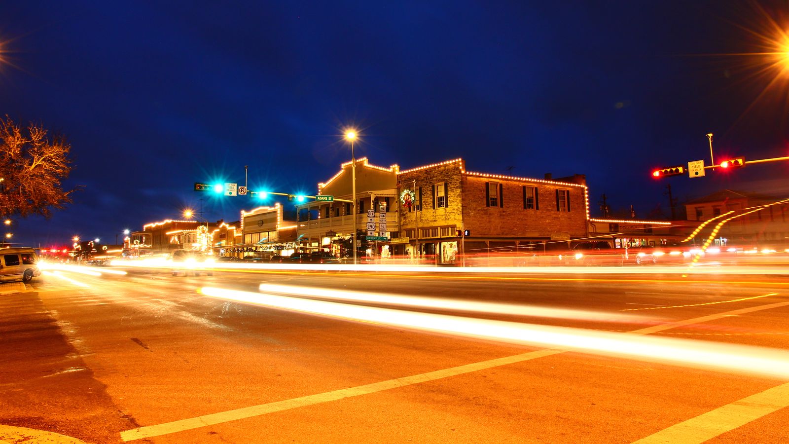 Nighttime lights of cars through an intersection in Fredericksburg TX