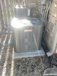 A Lennox HVAC Condenser system installed outside a home on a concrete slab
