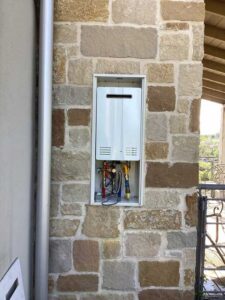 new tankless water heater installed outside home in Fredericksburg TX