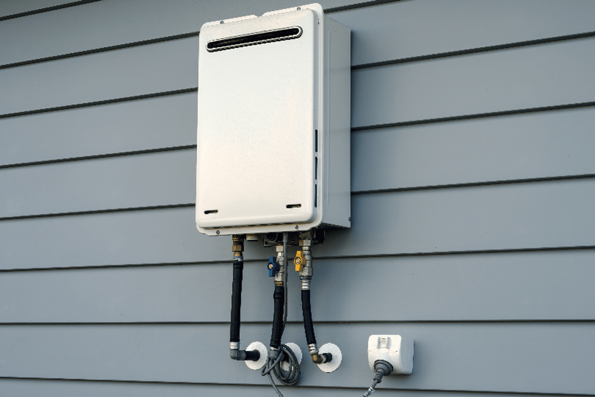 A tankless water heater installed outside a home
