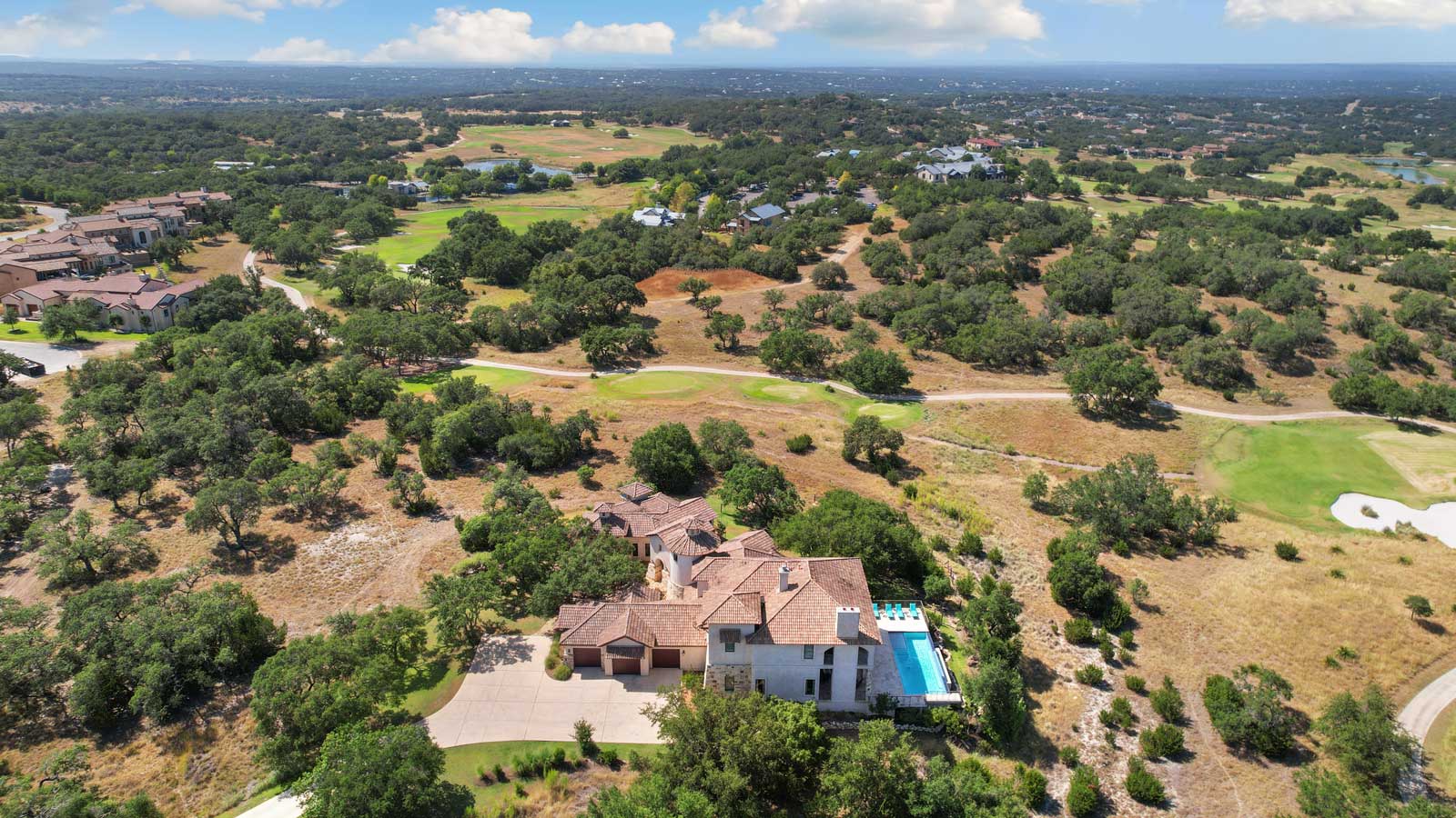 Luxurious residence with pool surrounded by lush hills and greenery in Texas